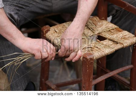 Senior Mender Of Chairs While With Straw Shelters The Old Wooden