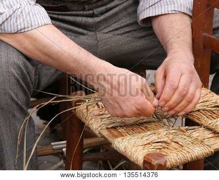 Mender Of Chairs While Repairing A Chair With Straw