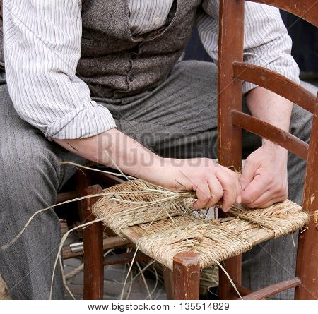 Hands Of An Elderly Craftsman While Reparing