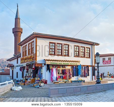 ANKARA TURKEY - JANUARY 16 2015: The scenic cottage of the modern neighborhood in old town with the wooden minaret on the background on January 16 in Ankara.