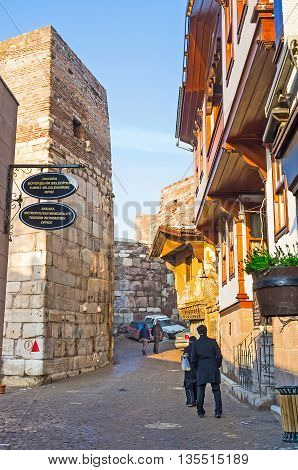 ANKARA TURKEY - JANUARY 16 2015: The narrow tourist street of the Turkish village with the tiny stalls and cozy cafes adjacent to the medieval fortress ramparts on January 16 in Ankara.