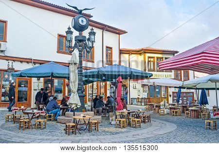 ANKARA TURKEY - JANUARY 16 2015: The cozy outdoor teahouse in the city center where locals like to spend their time drinking tea coffee and smoking on January 16 in Ankara.
