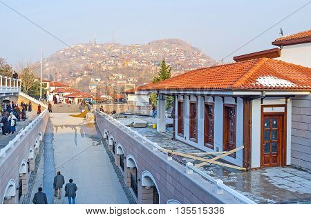 ANKARA TURKEY - JANUARY 16 2015: The modern market street of the old Ankara with the view on the hill with the slums of Ulus district on January 16 in Ankara.