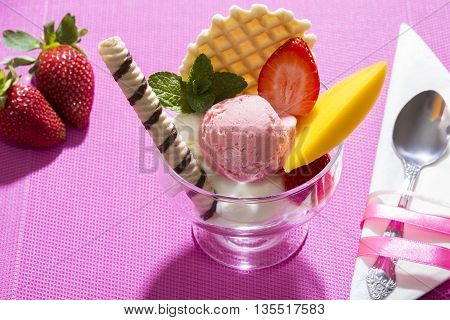 Strawberry ice cream dessert on a pink background