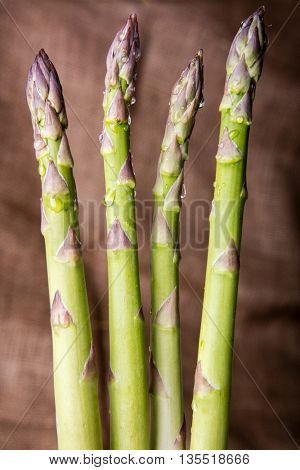 Raw green asparagus on wooden background
