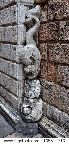 Strange sculpture of a monstrous fish outside St Margherita church in Venice