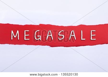 Torn paper with a MEGASALE word on red background.