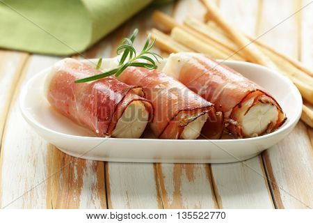 Italian appetizer soft cheese wrapped in parma ham