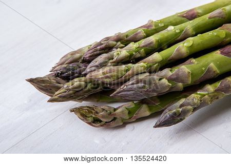 Green wet asparagus on the table