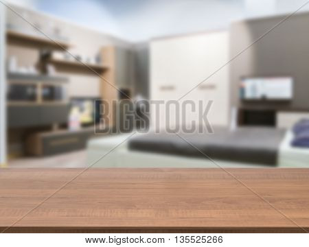 Wooden board empty table in front of blurred background. Perspective dark wood over blur in modern comfortable bedroom with white bed. Mock up for display or montage your products