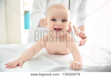 Professional pediatrician examining infant