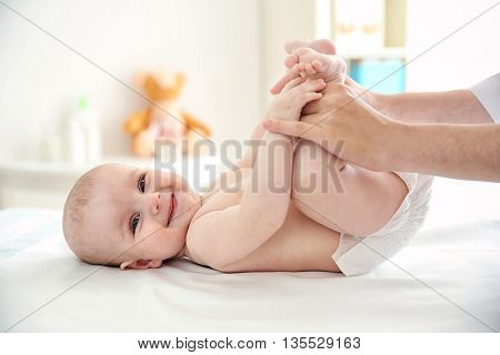 Doctor doing exercises with baby