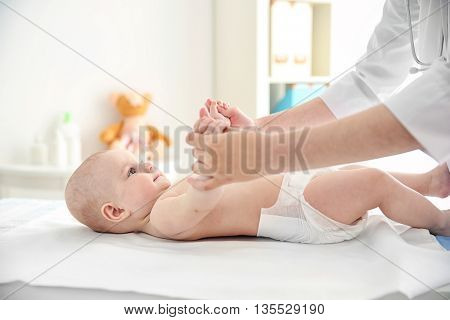 Doctor doing exercises with baby