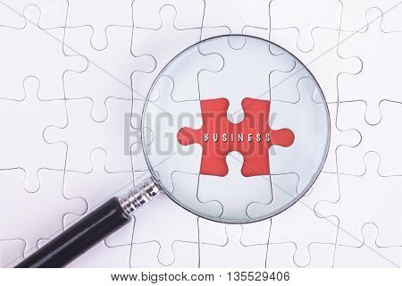 Business Concept - Magnifier Glass on white puzze with Business Word