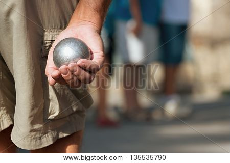 Senior playing petanque fun and relaxing game