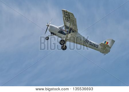 BRAILA, ROMANIA - MAY 28, 2016: Recreational flying airplane with smoke on air show demonstration flight. 