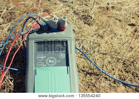 measurement of the earth. closeup of a three-phase electric cable