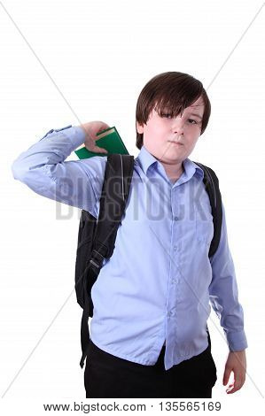 Schoolboy putting a book in a backpack isolated on a white background