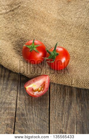 Red tomatoes on wooden surface. Selective focus