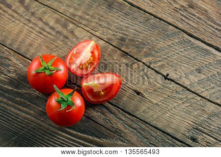 Ripe Tomatoes on wooden surface. Selective focus