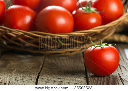 Ripe Tomatoes on wooden surface. Selective focus