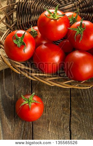 Ripe Tomatoes on wooden surface. Selective focus