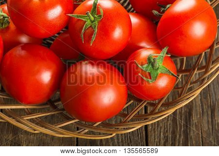 Ripe Tomatoes on wooden surface. Selective focus