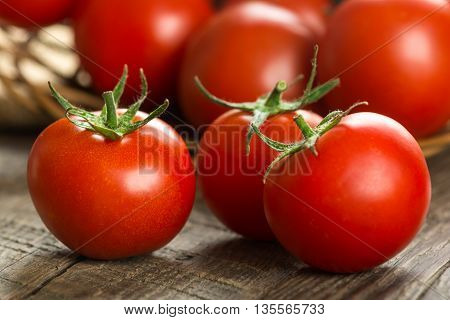 Ripe Tomatoes on wooden surface. Selective focus