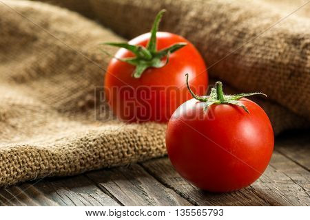Ripe Tomatoes on wooden surface. Selective focus