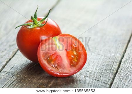 Ripe Tomatoes on wooden surface. Selective focus