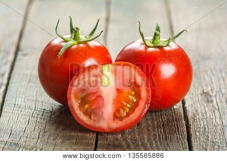 Ripe Tomatoes on wooden surface. Selective focus
