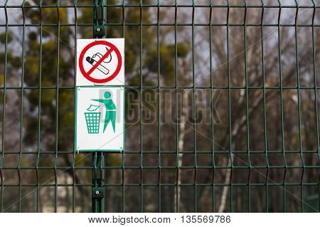 signs smoking is prohibited hanging on the fence