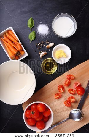 ingredients for tomatoes soup on black background