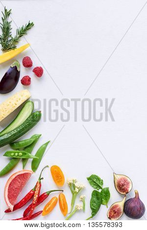Food background border frame of colorful fresh produce raw vegetables, corn carrot chilli cucumber purple cabbage spinach rosemary herb, plenty of copy-space