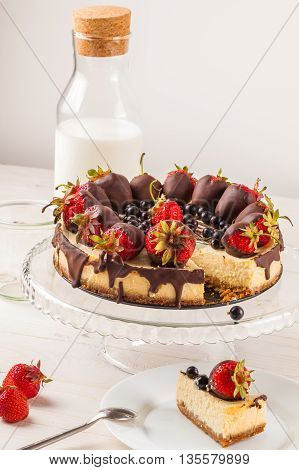 Delicious cheesecake with berries on table close up. White wooden background. Tasty dietary pastries. Natural product. Light dessert.