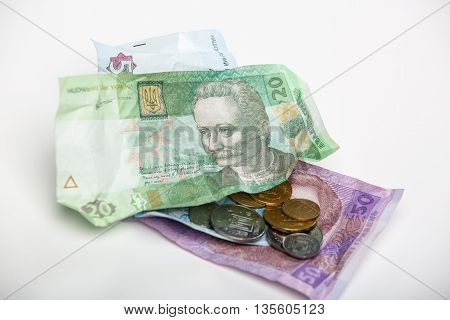 Ukrainian hryvnia currency and coins on a white background.