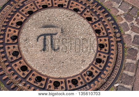 A manhole cover in Germany on asphalt