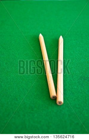 two wood pencil in green blackground, top view