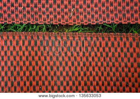 Close up a Bamboo mat between grass
