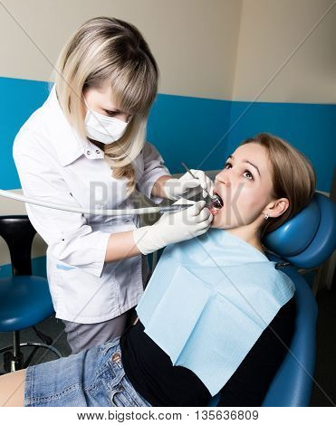 The reception was at the female dentist. Doctor examines the oral cavity on tooth decay. Caries protection. doctor puts the patient an anesthetic injection. close-up of the patient's mouth and squirt.