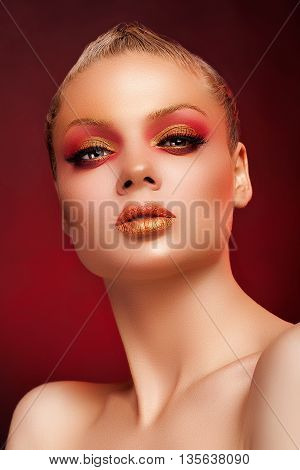 Woman With Art Stage Make Up On Red Background