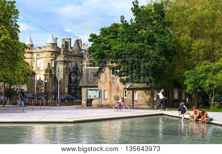 Edinburgh Scotland - July 24 2012: A pond with boys in the square in front of the Palace of Holyroodhouse.