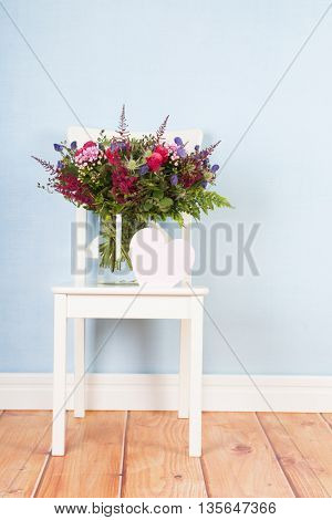Detail mixed bouquet flowers on blue background