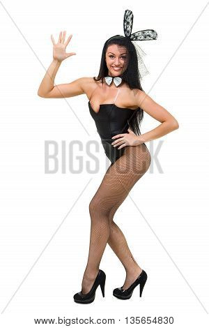 Sexy play girl wearing a bunny costume posing against isolated white background in full length.
