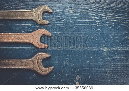 old rusty screw keys on the blue table