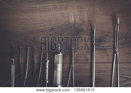 surgical armaments on the brown wooden table background