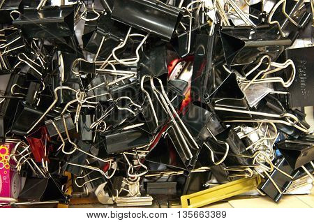 Many pile papred clips in box at office