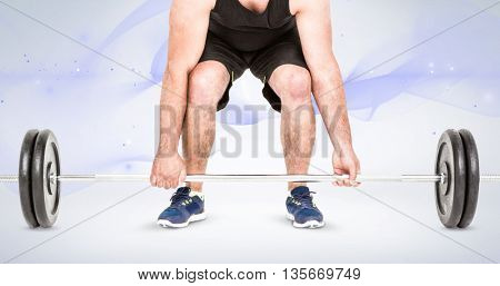 Bodybuilder lifting heavy barbell weights against grey background