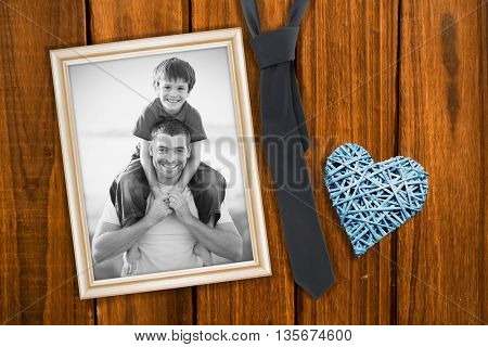 Father giving son piggyback ride against overhead of wooden planks