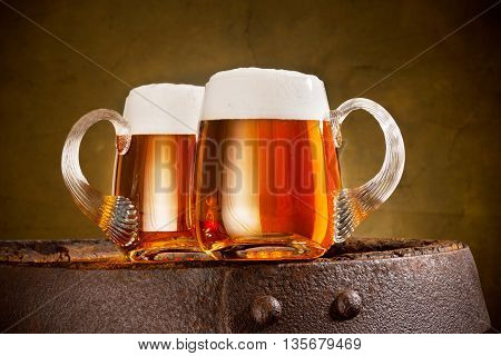 two glasses of beer on the old barrel